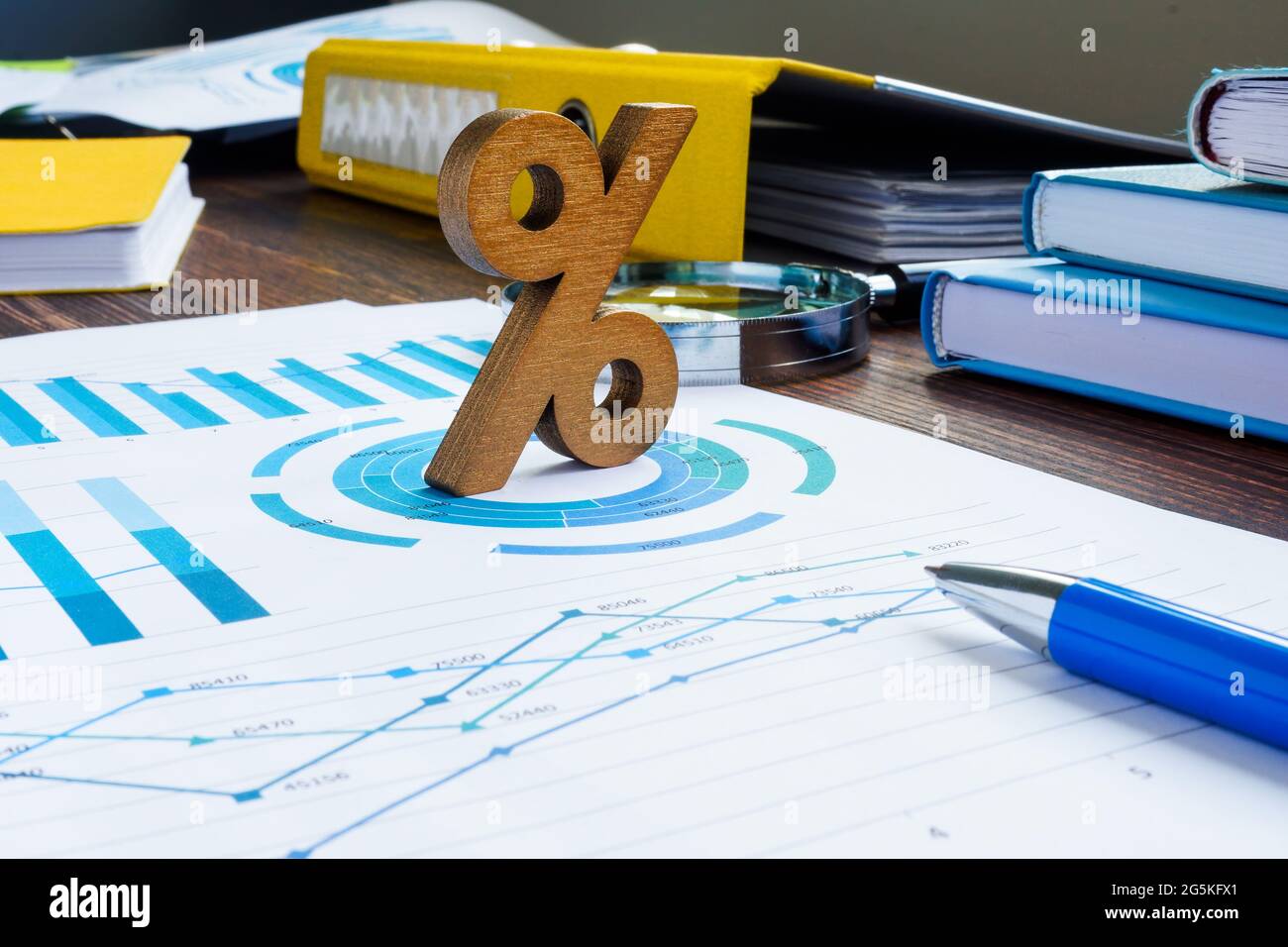 ROI return on investment concept. Percent sign and financial documents. Stock Photo