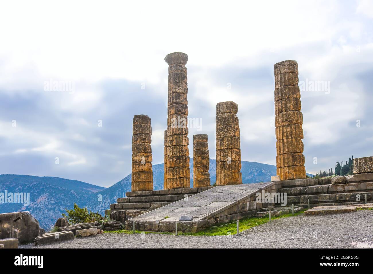 Reconstructed columns of Temple of Apollo at Delphi Greece overlook valley with far-off mountains on foggy day Stock Photo