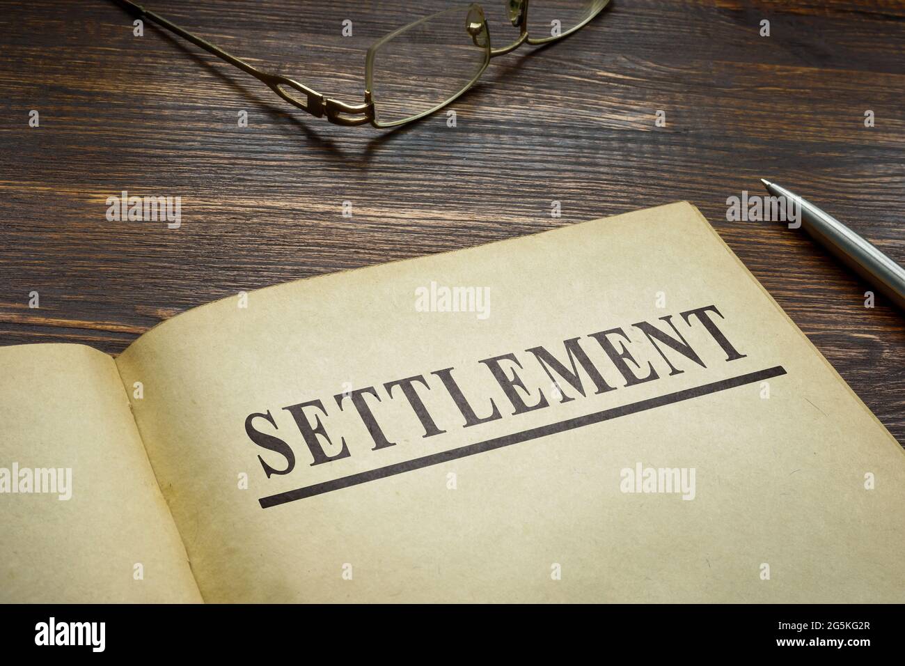 The Book about settlement and old glasses. Stock Photo