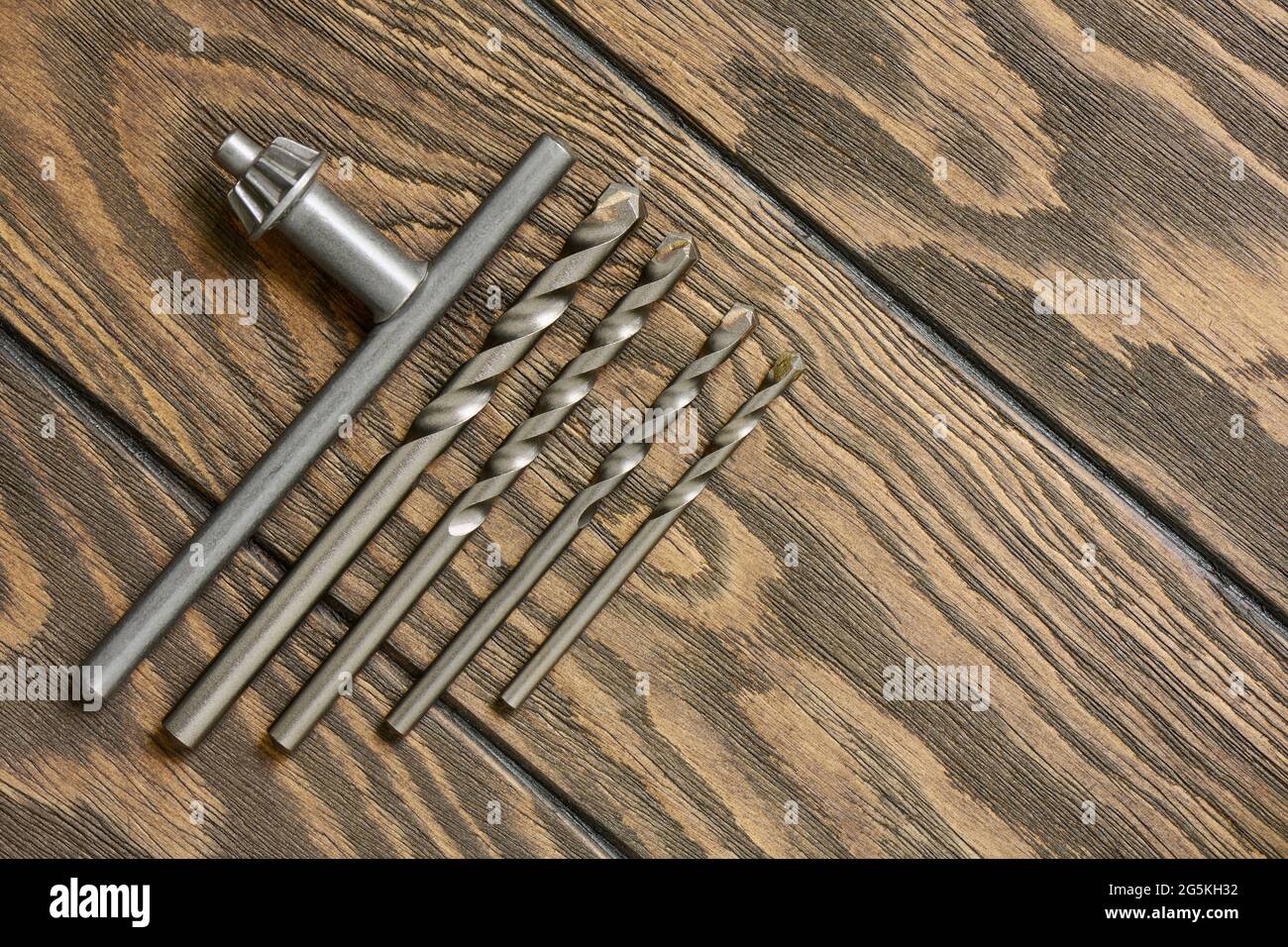 Key for chuck and concrete drills bit on wooden background Stock Photo