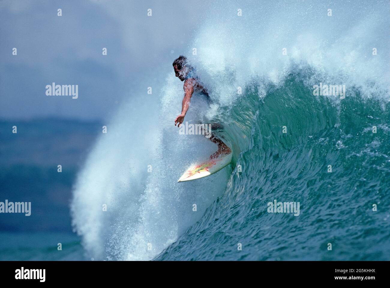 Surfing. Surfer on crest of breaking wave. Stock Photo