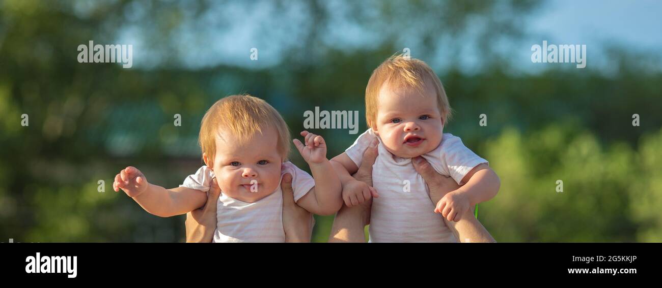Parents play toss their twin children over their heads Stock Photo Alamy