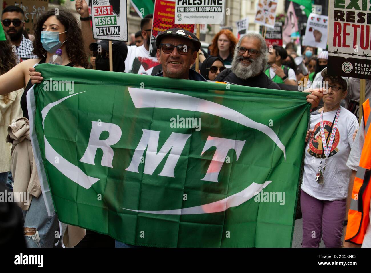 London protests, Activists protest in Central London at the People's Assembly National Demonstration, man holding the flag of the RMT the National Union of Rail, Maritime and Transport Workers Stock Photo