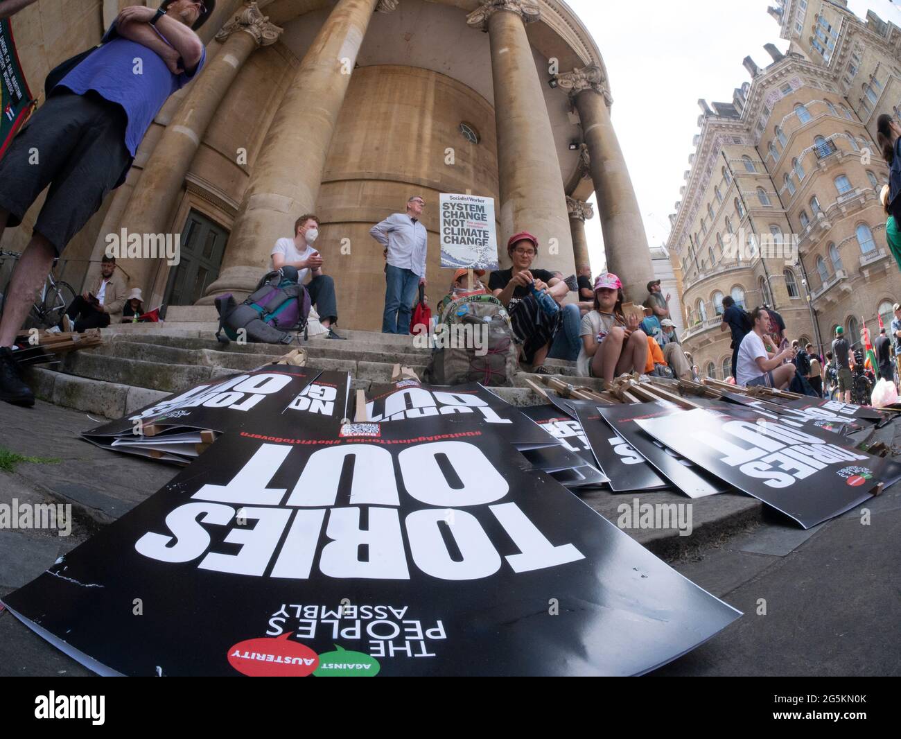 London protests, Activists protest in Central London at the People's Assembly National Demonstration, Tories out placards on pavement in foreground Stock Photo