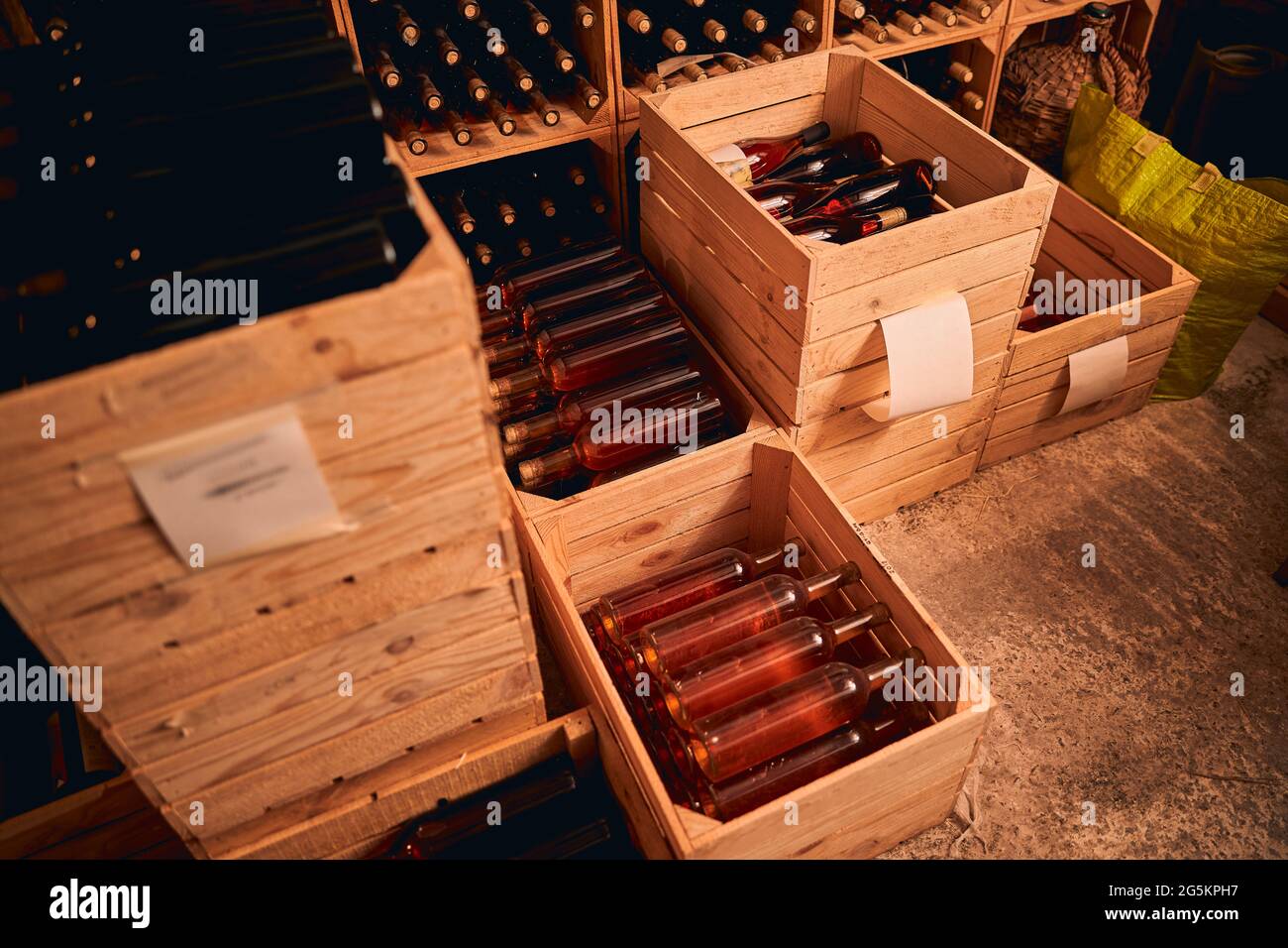 Wooden crates with bottles of wine in storage room Stock Photo