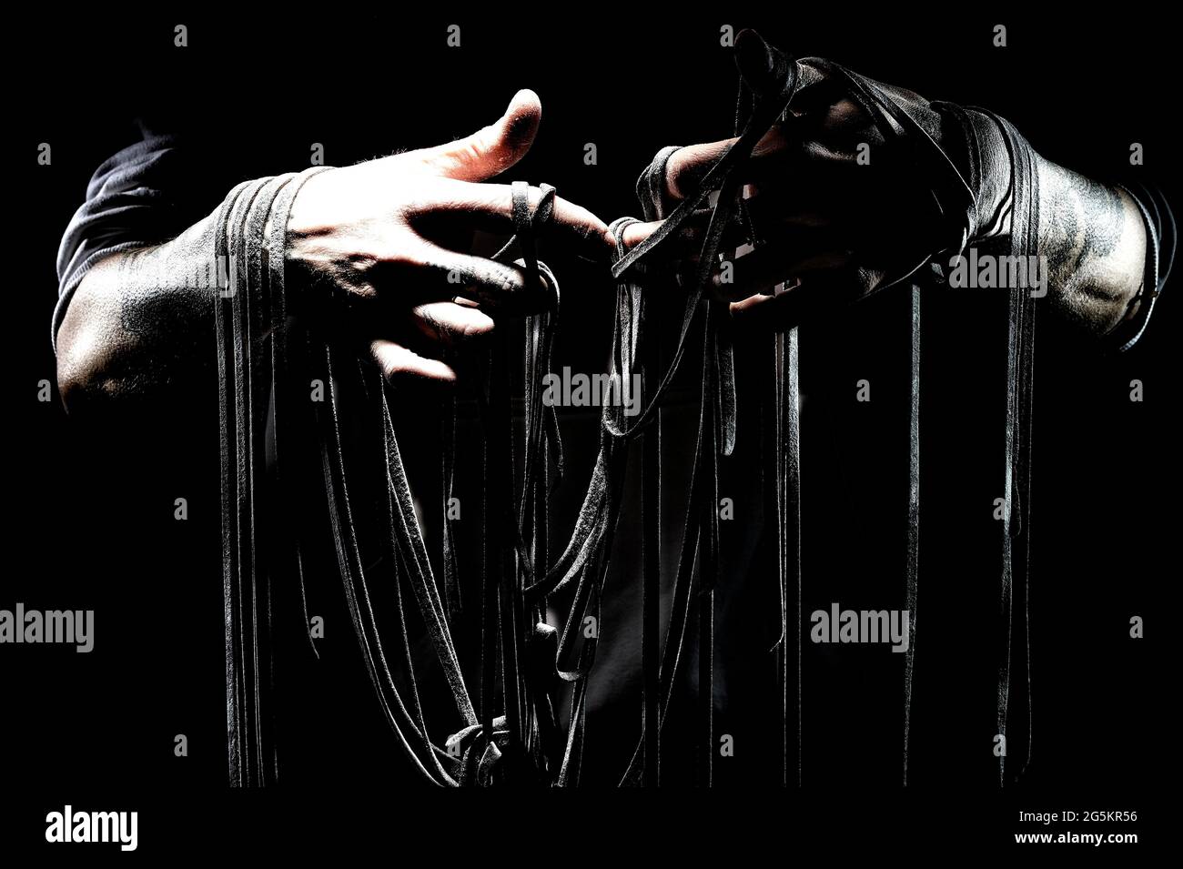 Black pasta with hands, Germany, Europe Stock Photo