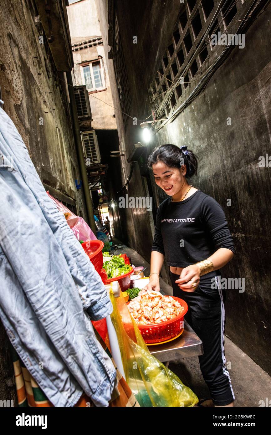 With A Back Alley As A Kitchen, A Cook Prepares A Pawn Entree Stock Photo
