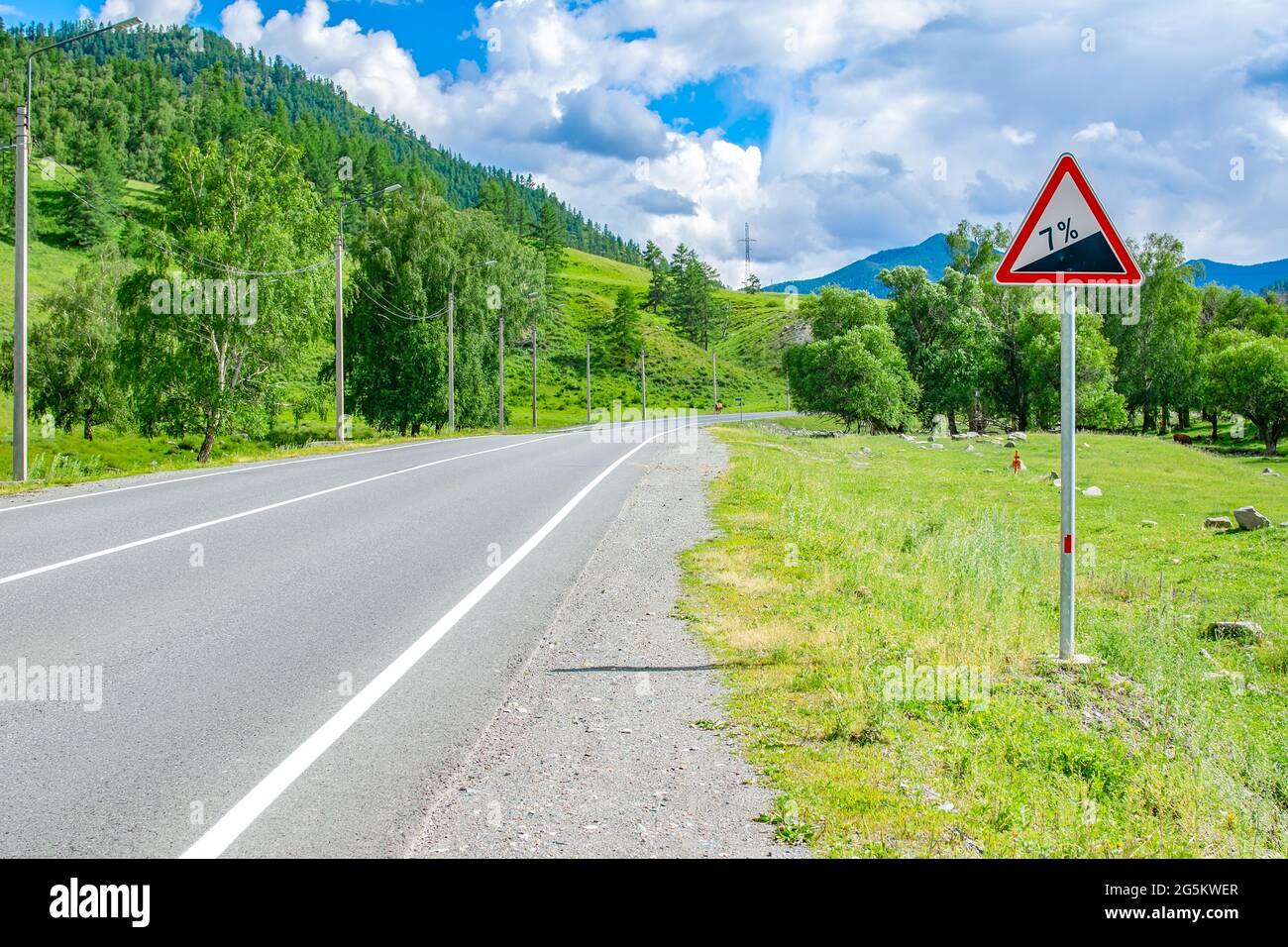 a road sign, a symbol for car drivers, warning about climbing uphill Stock Photo Alamy