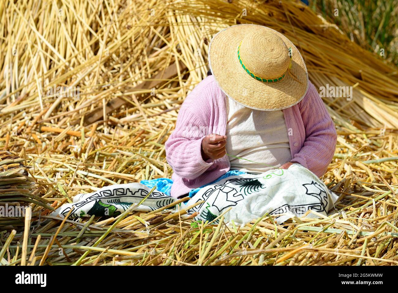 Indigenous woman embroidering on a Uro floating island, Lake Titicaca, Puno Province, Peru, South America Stock Photo