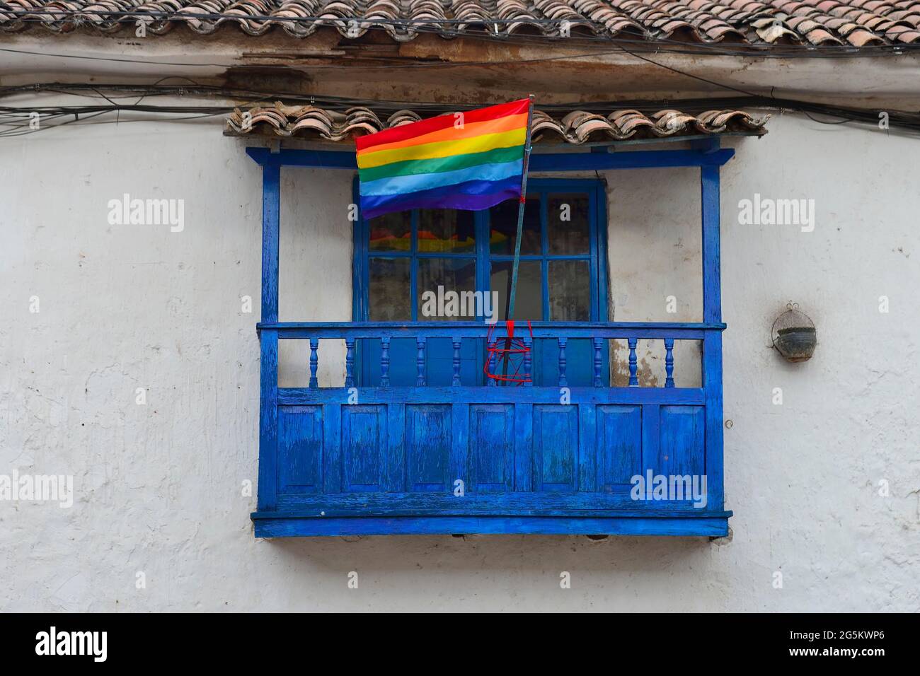 Flag of Cusco on a wooden balcony, Cusco, Peru, South America Stock Photo