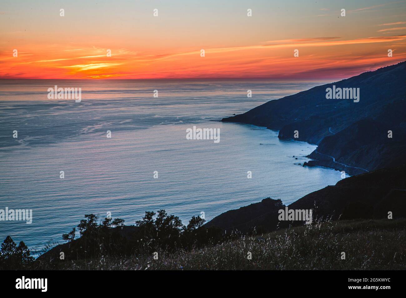 Sunset over Pacific Ocean and Big Sur Coast from mountain peak. Stock Photo