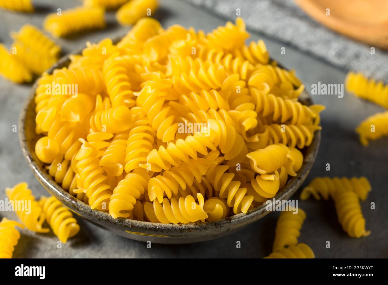 Dry Yellow Organic Rotini Pasta in a Bowl Stock Photo Alamy