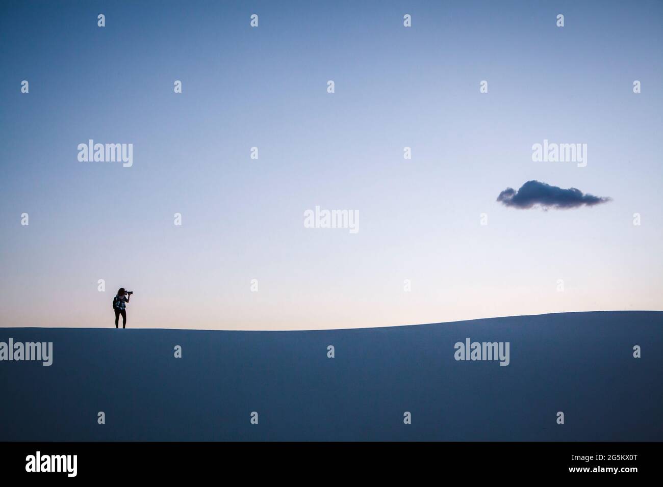 Silhouette of photographer and cloud, White Sands National Park Stock Photo