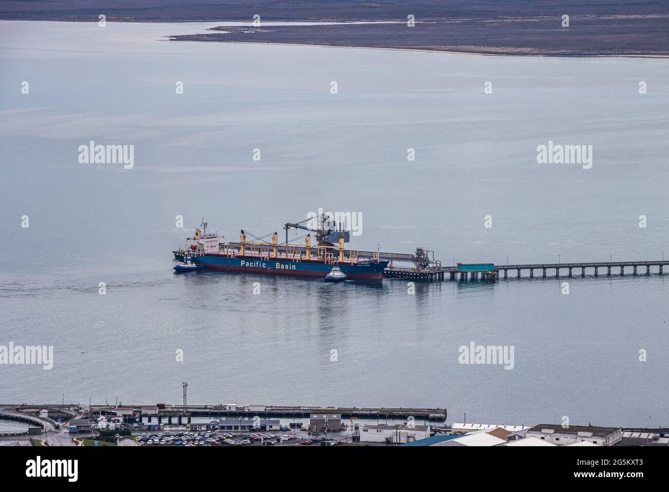 Ship anchored at wharf at Tiwai Point Aluminium Smelter Stock Photo
