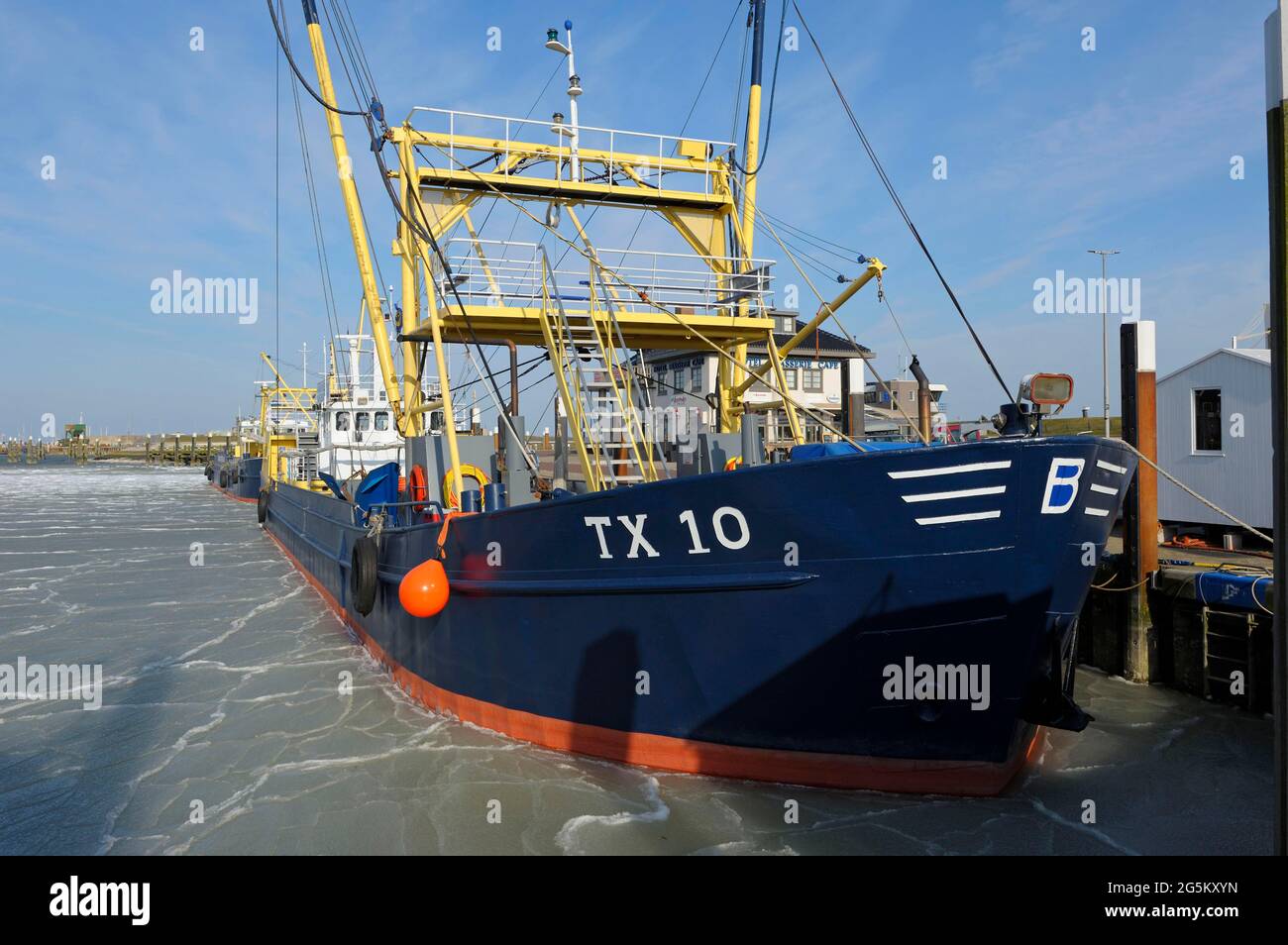 Fishing boat in the harbour of Oudeschild, frozen harbour basin, March 2013, Texel Island, North Sea, North Holland, Netherlands Stock Photo