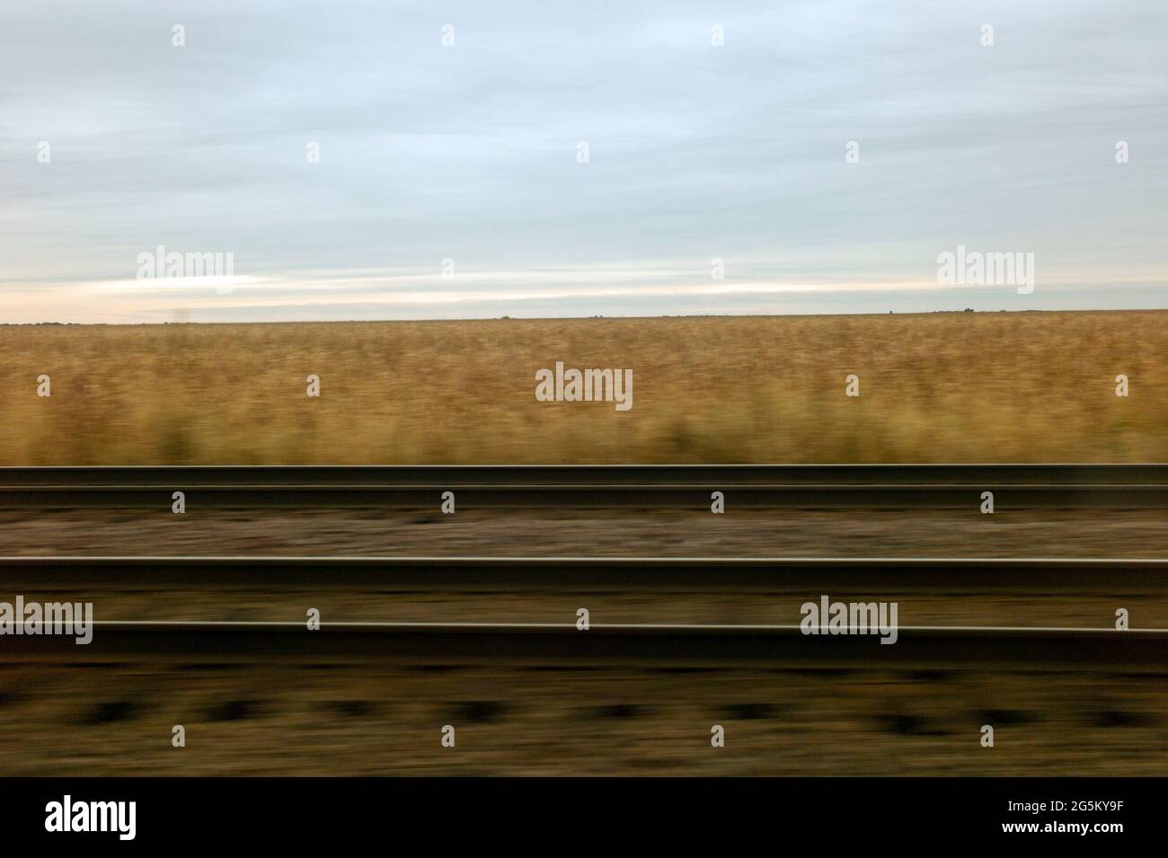 Riding parallel to railroad tracks on a passenger train in the country