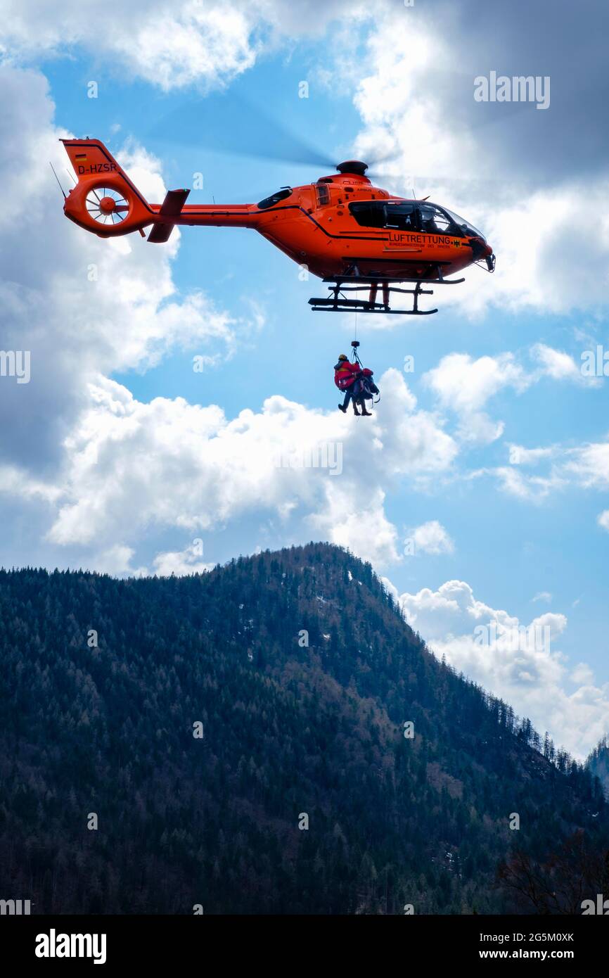 Two flight rescuers of the Bavarian Mountain Rescue Service hang on the ...