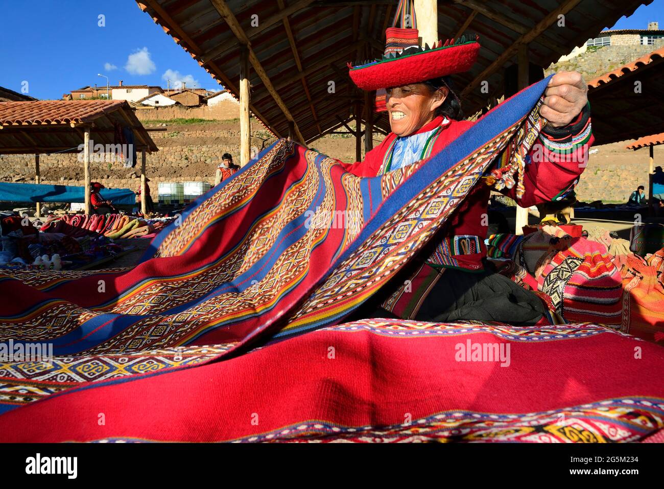 Indigenous old woman selling colorful blankets at the weekly market market, Chinchero, Cusco region, Urubamba province, Peru, South America Stock Photo