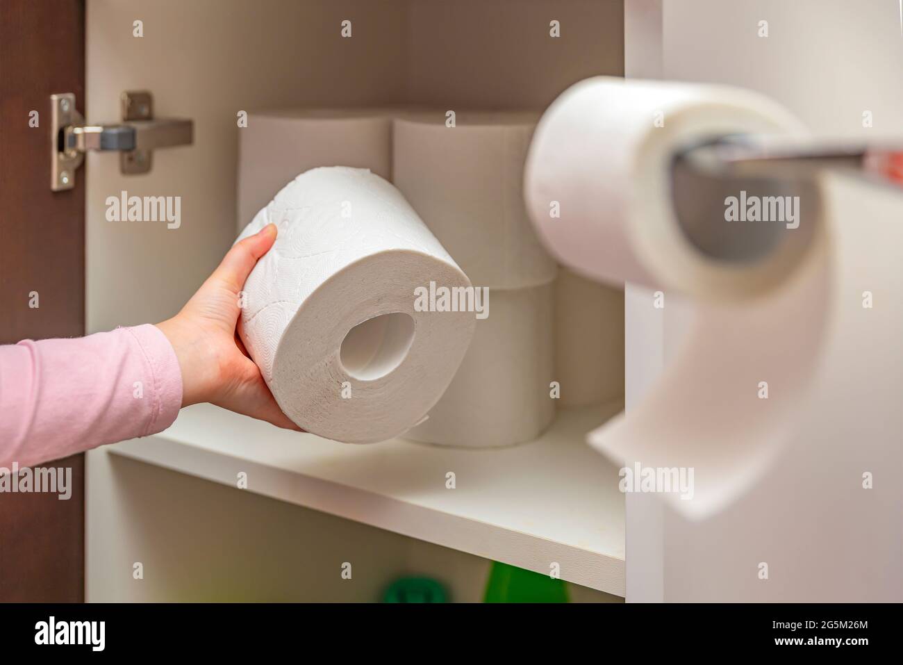 Toilet paper. Stocks of toilet paper. Girl puts toilet paper in the