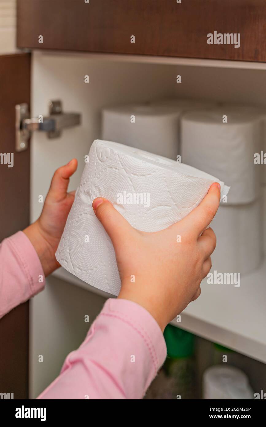 Toilet paper. Stocks of toilet paper. Girl puts toilet paper in the