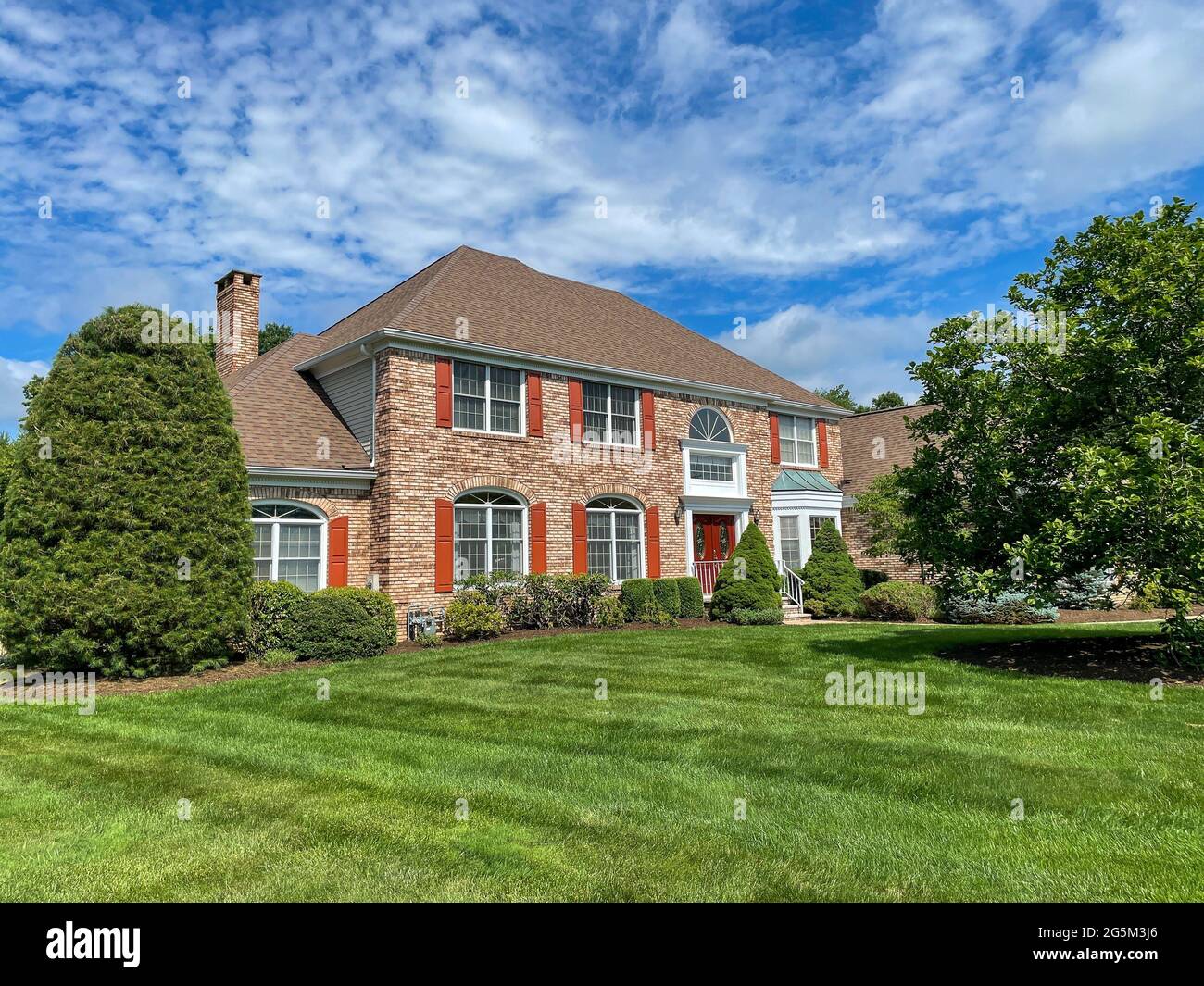 Single family suburban brick house in an affluent neighborhood in New Jersey. Stock Photo