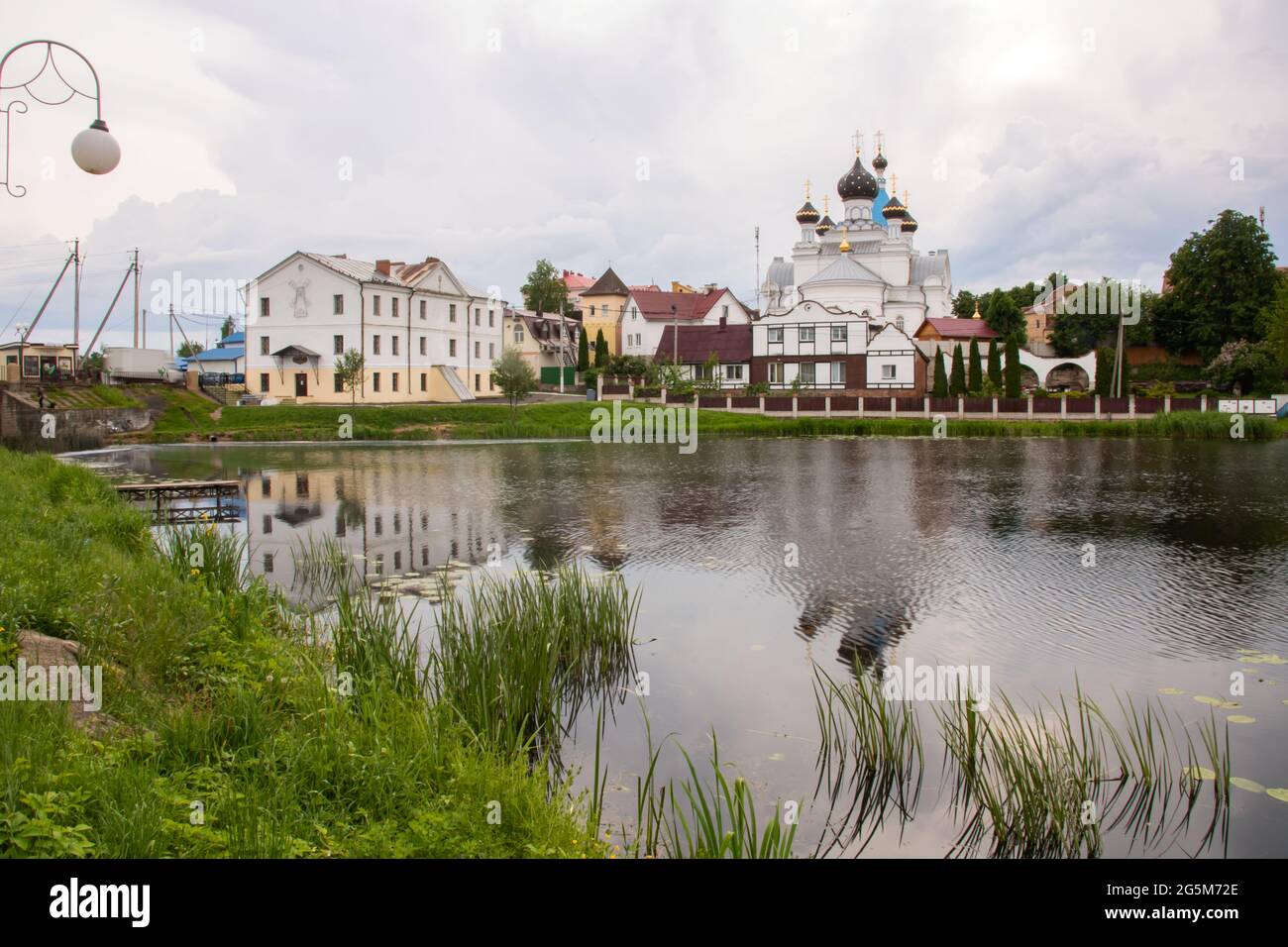 Domes of white orthodox church on river bank Stock Photo - Alamy