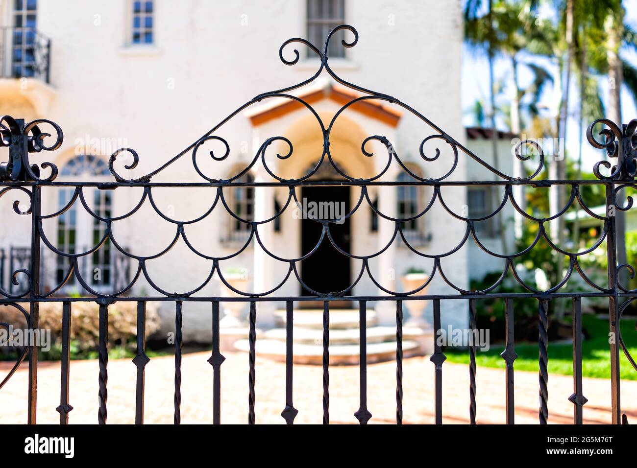 Hollywood, Florida in Broward County city in North Miami Beach area with entrance metal gate fence and background of luxury house mansion near the bea Stock Photo