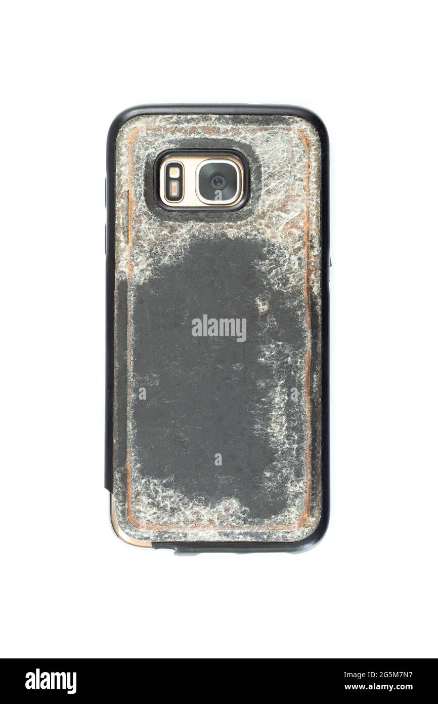 Mobile smartphone with camera in a used Old and dirty plastic case