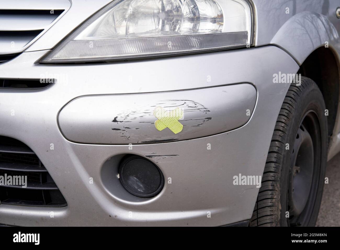 Band aid sticking plasters on a damaged section of car bodywork Stock Photo