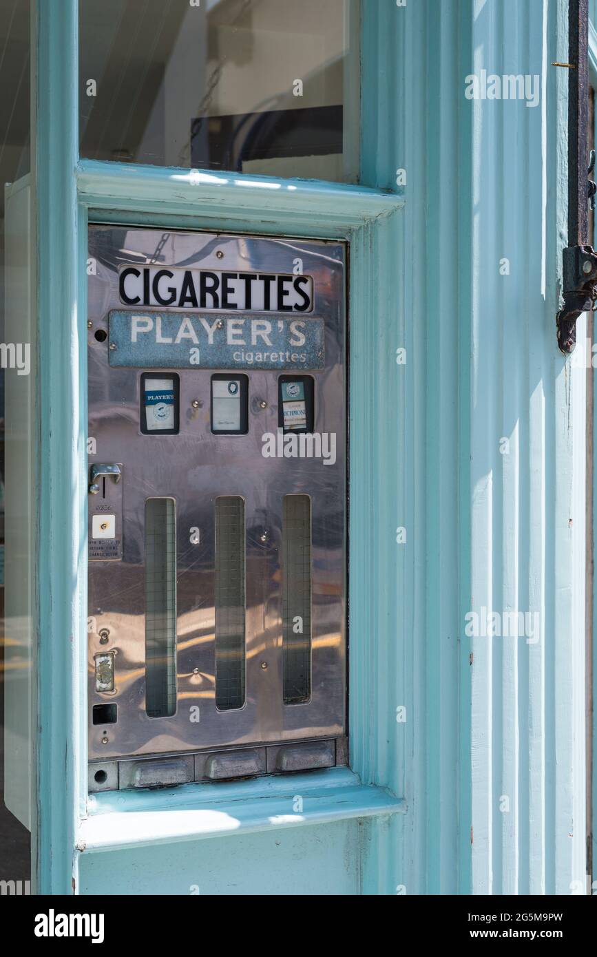 Defunct cigarettes dispensing machine in shop window. England, UK Stock Photo