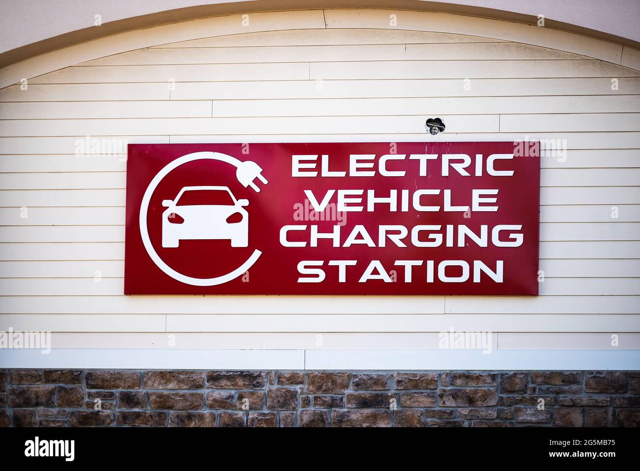 Sign on street road for Electric Vehicle Charging station with logo on building in Riverton Commons Plaza in Front Royal, Virginia USA Stock Photo