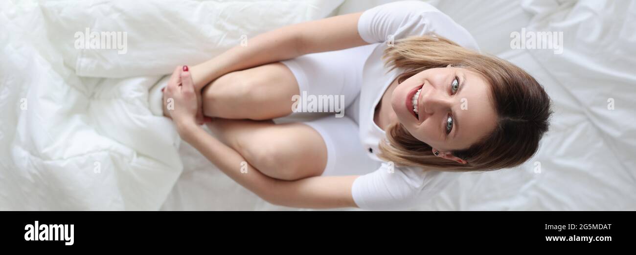 Young woman in pajamas in bed top view Stock Photo
