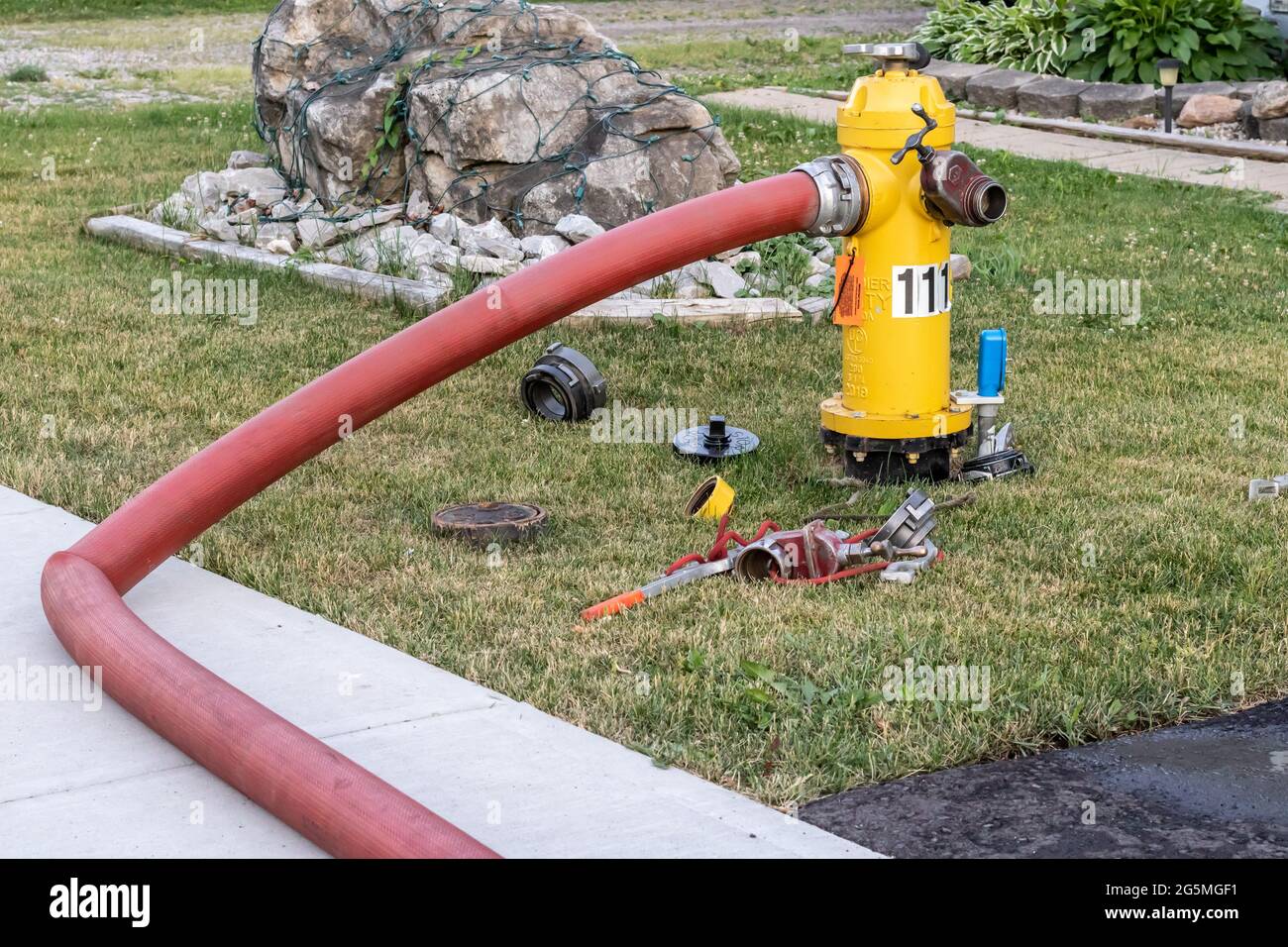 Fire hydrant water supply during emergency hooked to hose at day Stock  Photo - Alamy
