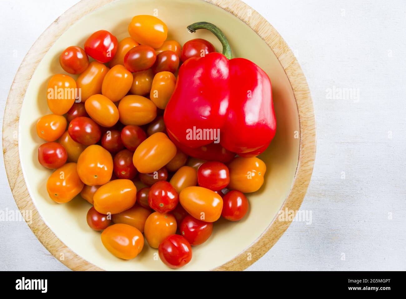 Bowl full fresh of cherry tomatoes and red bell pepper isolated on a ...