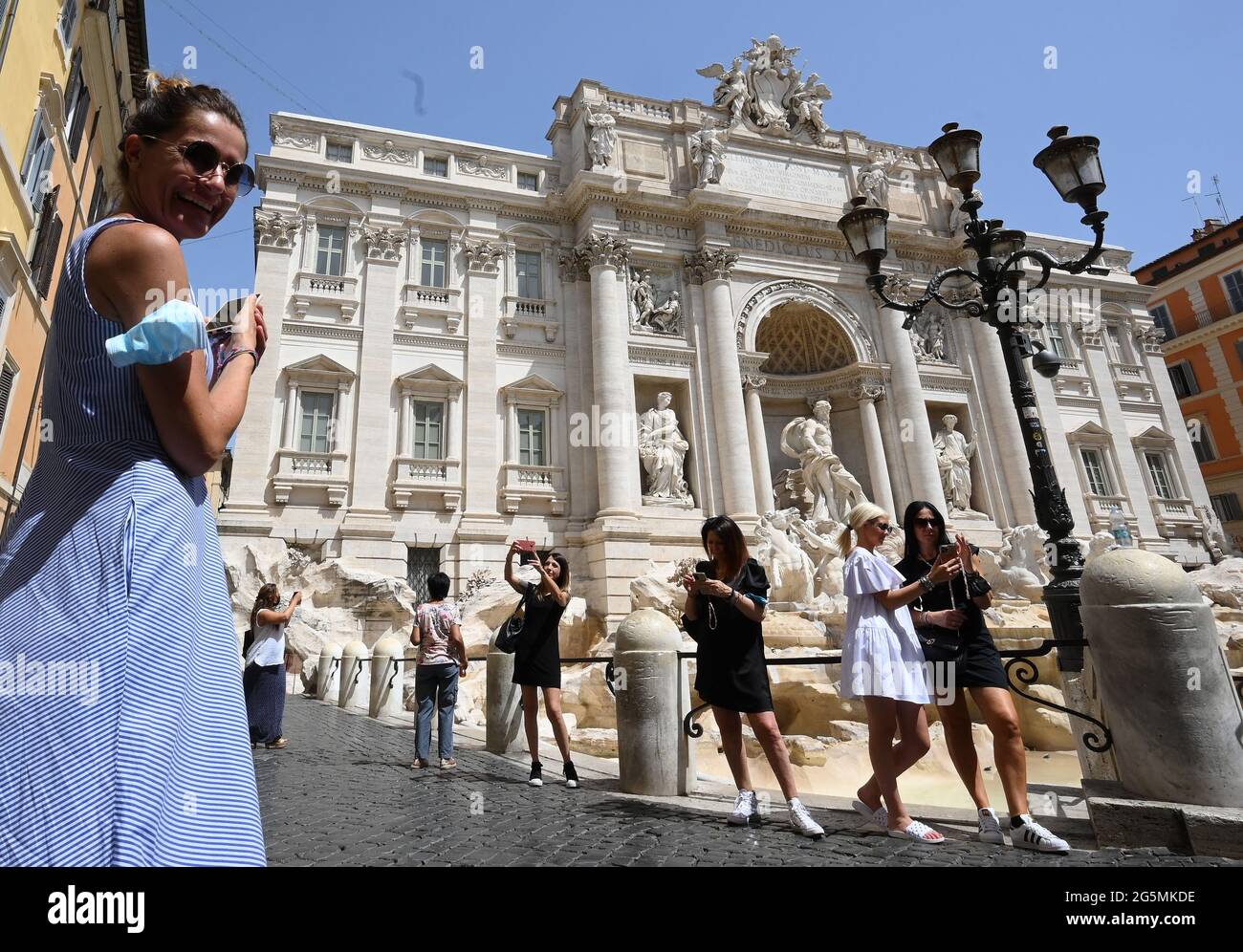 Rome, Italy. 28th June, 2021. People visit the Fontana di Trevi in