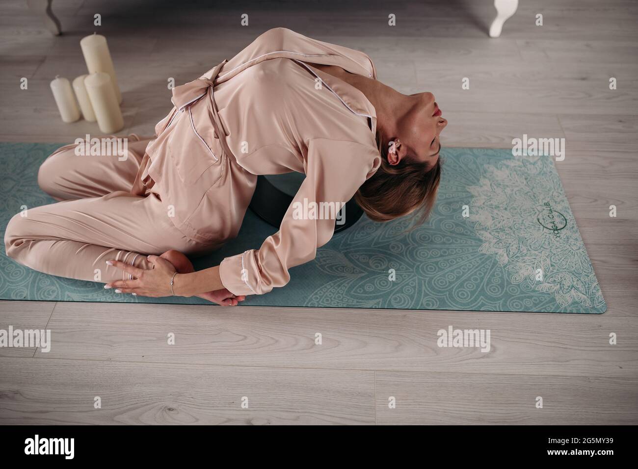 Young pretty lady doing asana at home on yoga mat Stock Photo - Alamy