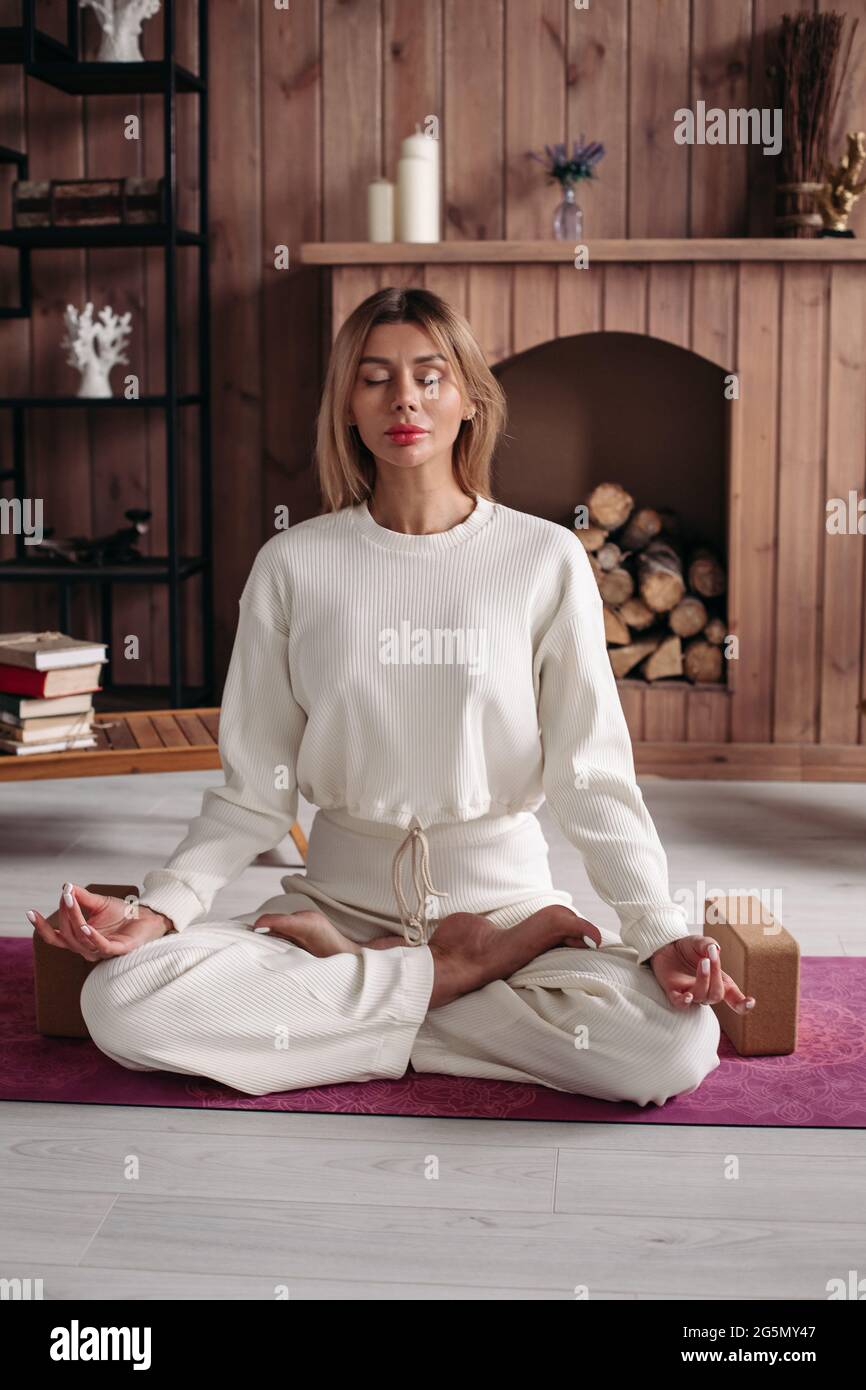 Pretty lady doing yoga at home in the lotus position Stock Photo - Alamy