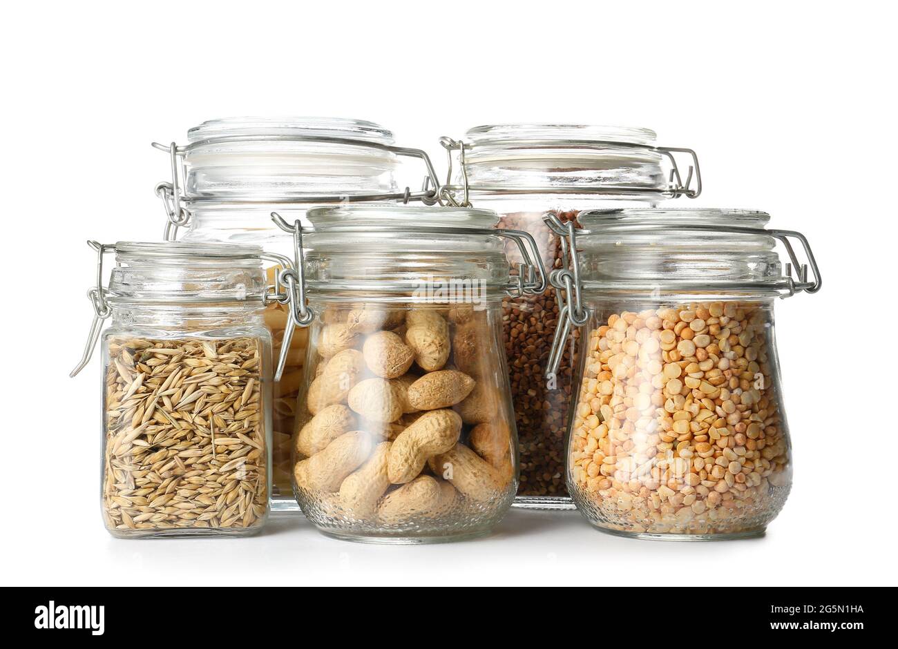 Glass jars with different products on white background Stock Photo - Alamy