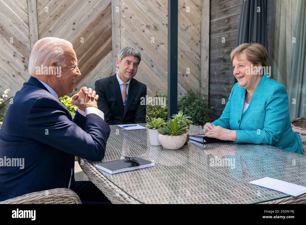 President Joe Biden meets for a brief pull-aside meeting with German Chancellor Angela Markel during the G7 Summit at the Carbis Bay Hotel and Estate on Saturday, June 12, 2021, in St. Ives, Cornwall, England. (Official White House Photo by Adam Schultz) Stock Photo