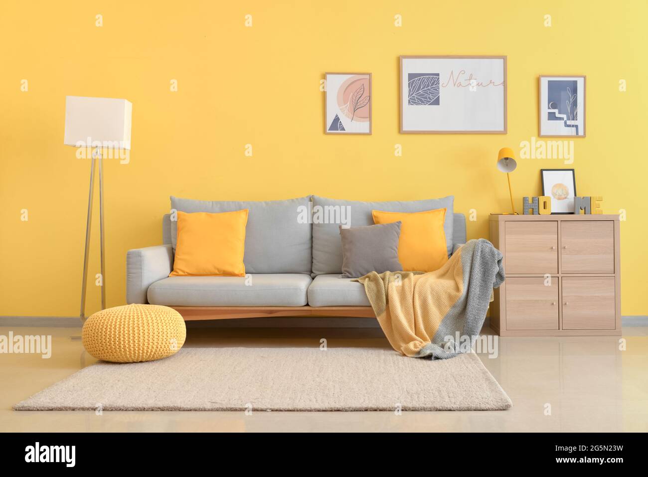 Interior of stylish living room with pictures Stock Photo - Alamy