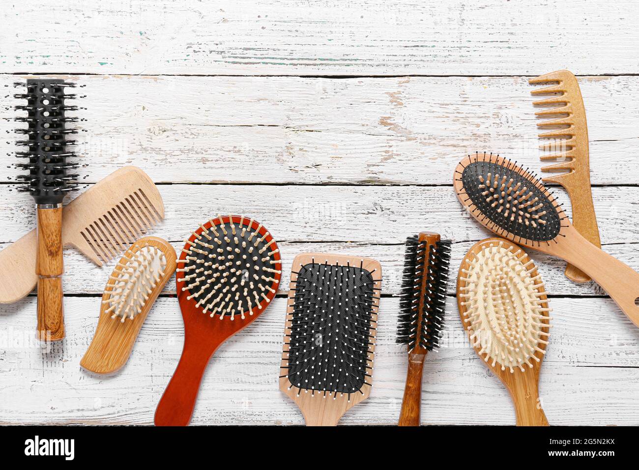 Top 10 best hair brushes for guys arranged on a wooden surface