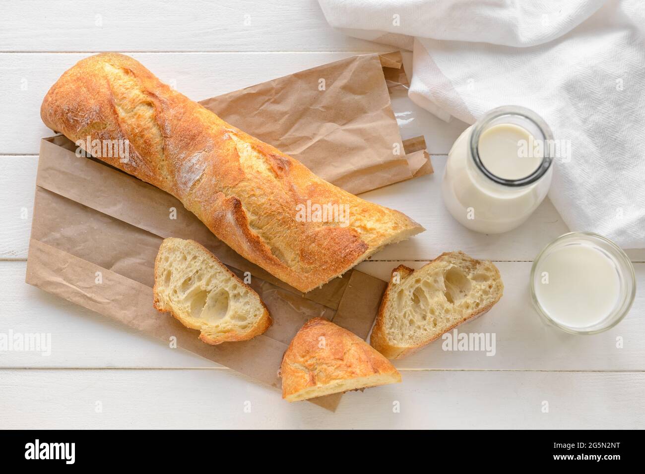French baguette on white wooden background Stock Photo - Alamy