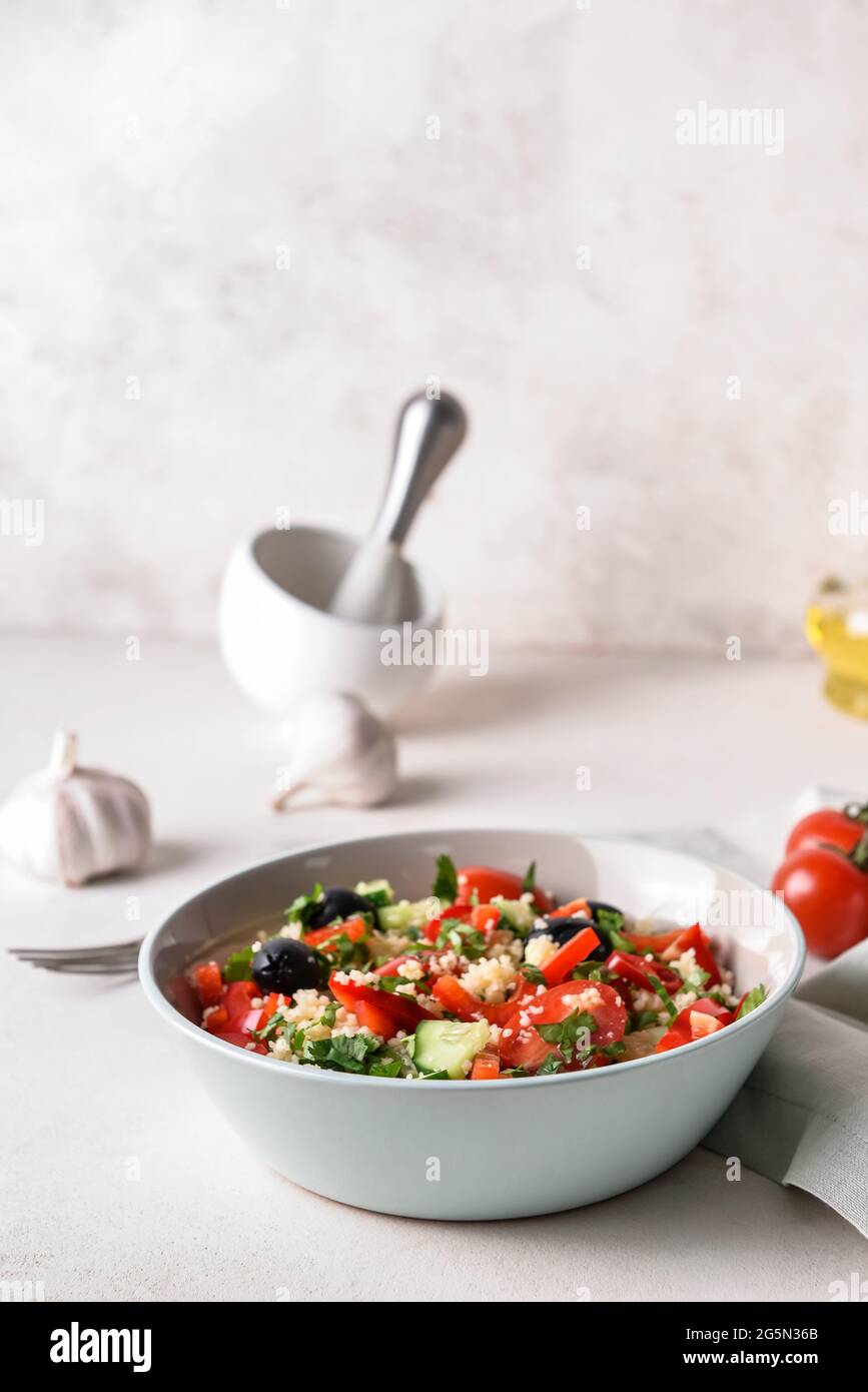 Bowl With Couscous And Vegetables On Light Background Stock Photo - Alamy