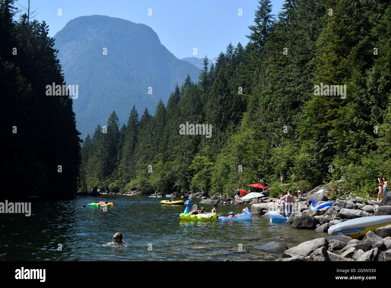 People cool off in Alouette Lake during the scorching weather of a heatwave in Maple Ridge, British Columbia, Canada June 28, 2021. REUTERS/Jennifer Gauthier Stock Photo
