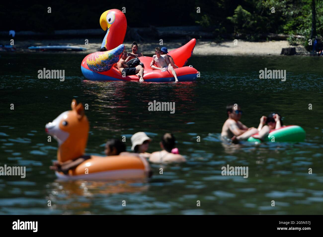People head to Alouette Lake to cool off during the scorching weather of a heatwave in Maple Ridge, British Columbia, Canada June 28, 2021. REUTERS/Jennifer Gauthier Stock Photo
