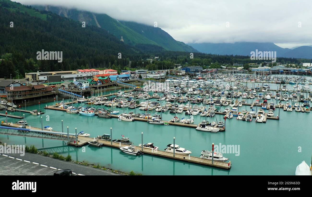 The water is turqouise blue in the port of Seward Alaska Stock Photo