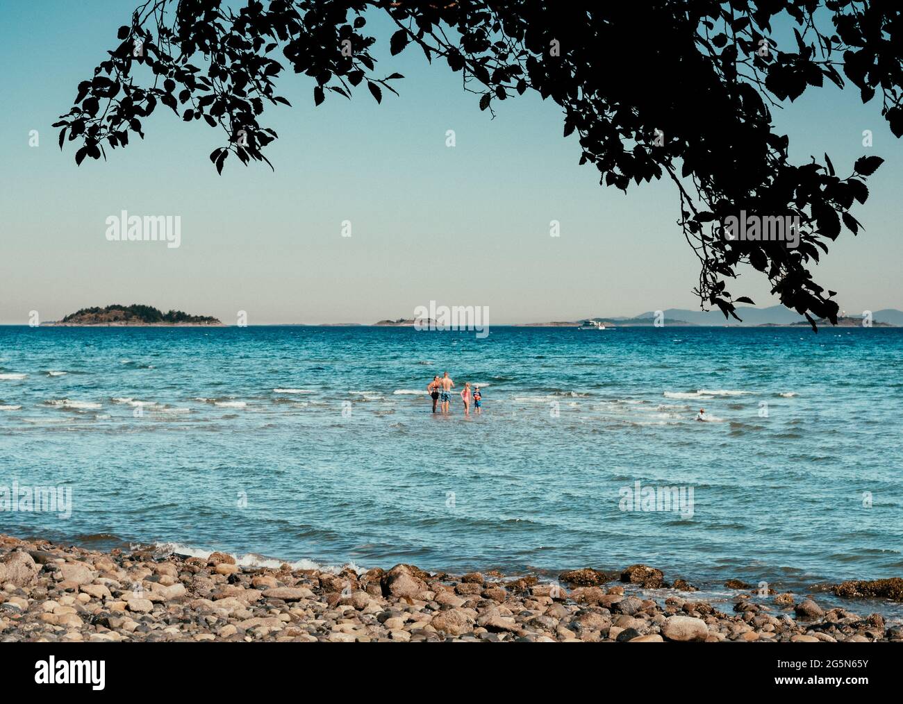 Family enjoying the ocean at Blueback Beach on Vancouver Island, BC