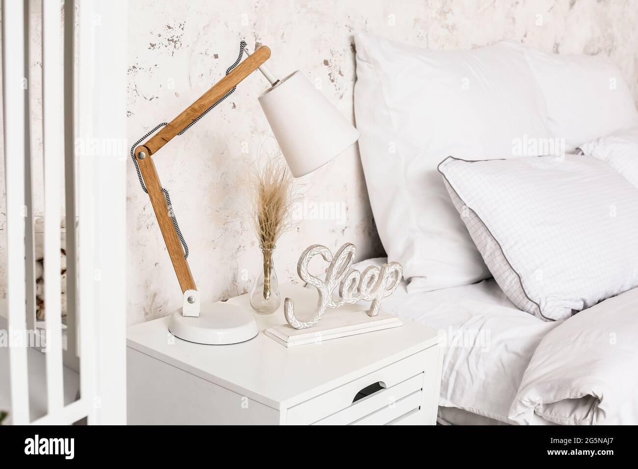 Modern lamp on bedside table in interior of bedroom Stock Photo Alamy