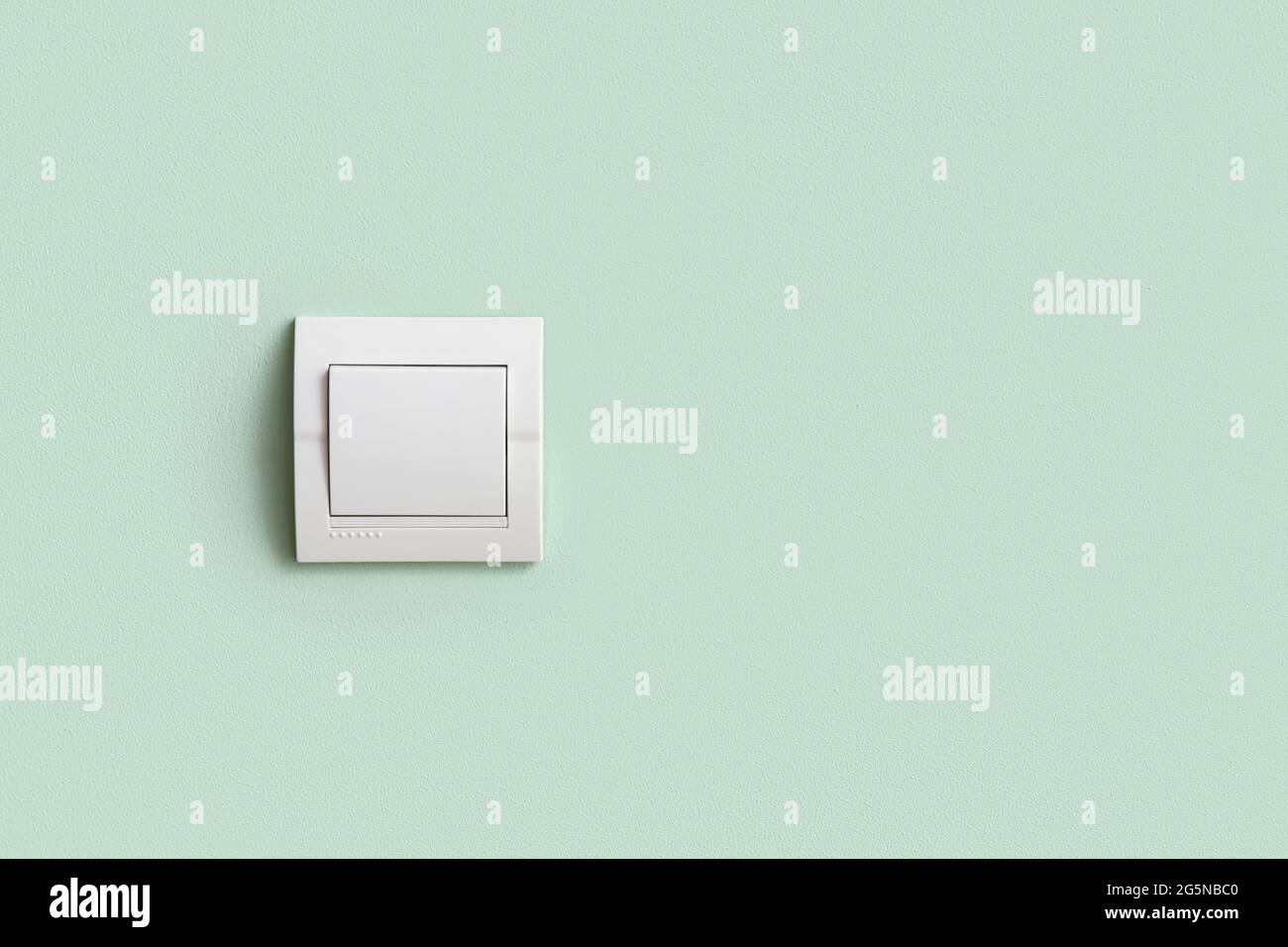 Modern switch on light color wall Stock Photo - Alamy