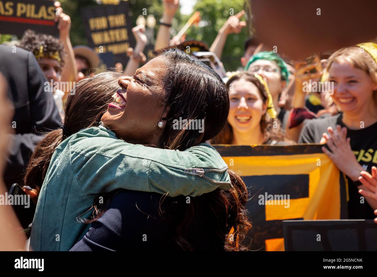 Washington, DC, USA, 28 June, 2021.  Pictured: Congresswoman Alexandria Ocasio-Cortez (D-NY) (left) greets Congresswoman Cori Bush (D-MO) (right) after Bush speaks to hundreds of protesters in Lafayette Square in front of the White House.  Protesters are young adults who are members of the Sunrise Movement.  They have 3 demands of the Biden Administration: no compromises on climate with Congressional Republicans, meeting with Sunrise Movement, and the creation of a Civilian Conservation Corps.  Credit: Allison Bailey / Alamy Live News Stock Photo